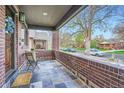 Cozy front porch with tile flooring and brick accents, perfect for relaxing at 2039 S Corona St, Denver, CO 80210