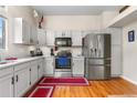 Modern kitchen with stainless steel appliances, granite countertops, and white cabinetry at 4707 N Bearlily Way, Castle Rock, CO 80109