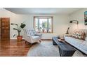Cozy living room with natural light, hardwood floors, comfortable seating, and stylish decor at 1641 S Parfet Ct, Denver, CO 80232