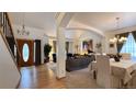 Inviting living room with an open floor plan, chandelier, and large front door at 19850 Indian Summer Ln, Monument, CO 80132