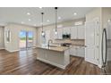 Modern kitchen with stainless steel appliances, gray countertops, hardwood floors, and pendant lighting over the island at 5909 S Platte Canyon Dr, Littleton, CO 80123