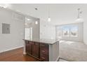 Bright living room featuring an island, carpet flooring, and large windows allowing ample natural light at 13598 Via Varra # 105, Broomfield, CO 80020