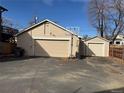 Spacious garage with multiple bays, basketball hoop, and ample parking space at 2469 Ames St, Edgewater, CO 80214