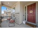 Inviting front porch with chairs, a welcome mat, and a charming front door at 24432 E Tennessee Pl, Aurora, CO 80018