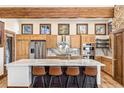 Open kitchen features a large island with bar seating, stainless steel appliances, and natural wood cabinets at 94 Lake View Dr, Breckenridge, CO 80424