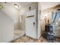 Entryway with tile flooring, staircase, coat hooks, and rustic decor at 9674 Fox Den Dr, Littleton, CO 80125