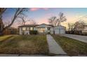 Inviting single story home with a detached garage and large front yard at 555 Everett St, Lakewood, CO 80226