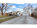 Cozy home with a detached two-car garage and a long driveway at 555 Everett St, Lakewood, CO 80226