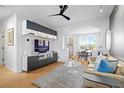 Bright living room with modern built-ins, hardwood floors, and an open layout leading to the dining area at 84 Spruce St # 707, Denver, CO 80230