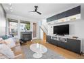 Cozy living room featuring a fireplace, sleek built-ins, hardwood floors, and a sliding door to the outside at 84 Spruce St # 707, Denver, CO 80230