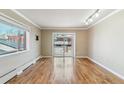 Bright open living room featuring large windows, hardwood floors, and access to a balcony at 1330 Elizabeth St # 8, Denver, CO 80206