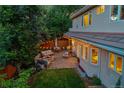Aerial view of a backyard featuring an outdoor seating area with a fire pit and string lights at 2558 Premier Pl, Boulder, CO 80304