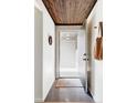 Inviting entryway features modern lighting, tiled floor, and convenient coat storage at 199 S Ivy St, Denver, CO 80224