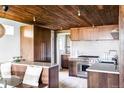 Modern kitchen with light floors, wood cabinets, stainless steel appliances and breakfast nook at 199 S Ivy St, Denver, CO 80224