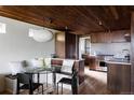 Modern kitchen with light floors, wood cabinets, stainless steel appliances and breakfast nook at 199 S Ivy St, Denver, CO 80224