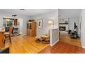 Cozy living room with hardwood floors, a fireplace, and a comfortable chair at 12906 Cherry Way, Thornton, CO 80241