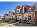 Attractive townhomes offer stone accents, neutral siding, black shutters, well-manicured front yards, and cozy patios at 3751 W 136Th Ave # S3, Broomfield, CO 80023