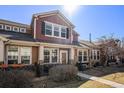 Inviting townhome boasts a well-maintained front yard, stone accents, neutral siding, and a quaint front patio at 3751 W 136Th Ave # S3, Broomfield, CO 80023