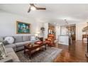 Spacious living room with hardwood floors, a comfortable gray sofa, and an inviting view into the modern kitchen at 3751 W 136Th Ave # S3, Broomfield, CO 80023