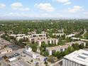Wide aerial shot showcasing the community amidst lush greenery and distant mountain views at 3470 S Poplar St. # 110, Denver, CO 80224