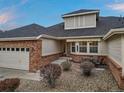 Charming ranch-style home featuring a brick facade, attached garage, and landscaped front yard at 7560 S Biloxi Ct, Aurora, CO 80016