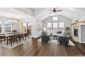 Open-concept living room and dining area with wood floors and plenty of natural light at 7560 S Biloxi Ct, Aurora, CO 80016