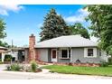 Charming single-story home with well-kept lawn, brick chimney, attached carport, and mature trees at 6755 W 45Th Ave, Wheat Ridge, CO 80033