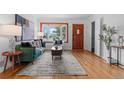 Bright living room boasts hardwood floors, a bay window, stylish furnishings, and a decorative front door at 6755 W 45Th Ave, Wheat Ridge, CO 80033