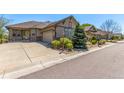 Beautiful home with a well-maintained yard, a spacious driveway, and stone accents on the facade at 7580 S Biloxi Ct, Aurora, CO 80016