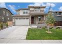 Stylish two-story home with a spacious two-car garage, stone details, and a welcoming front lawn at 14818 Dahlia St, Thornton, CO 80602
