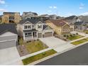 Aerial view of a charming two-story home with a three-car garage and beautiful landscaping at 13041 Reata Ridge Dr, Parker, CO 80134