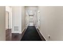 Inviting hallway with hardwood floors and neutral paint at 1388 Castle Creek Cir, Castle Rock, CO 80104