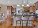 Stylish kitchen with granite countertops, stainless steel appliances, and a breakfast bar at 413 N De Gaulle Ct, Aurora, CO 80018