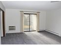 Bright living room with sliding glass doors to a balcony, perfect for enjoying the view at 13952 E Marina Dr # 304, Aurora, CO 80014