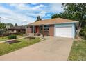 Beautiful single-Gathering home featuring an attached garage and a spacious driveway at 1666 S Bryant St, Denver, CO 80219