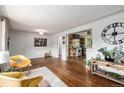 Cozy living room features hardwood floors, neutral paint, and stylish accents at 1666 S Bryant St, Denver, CO 80219