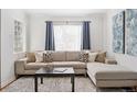 Cozy living room showcases neutral sectional sofa, plush rug, and stylish decor at 1580 Quince St, Denver, CO 80220