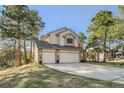 Inviting two-story home with a three car garage, brick accents, and a spacious driveway at 25875 Buffalo Ln, Golden, CO 80401