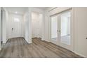 Bright entryway with wood floors and glass paneled doors at 1613 Bloom St, Brighton, CO 80601