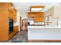 Well-lit kitchen boasts modern appliances, a large island, and ample cabinet space for storage at 6668 Fairways Dr, Longmont, CO 80503