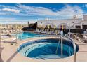 Rooftop pool and jacuzzi with lounge chairs and umbrellas offer scenic city views at 3701 Arapahoe Ave # 318, Boulder, CO 80303