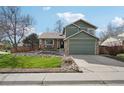 Charming two-story home with a lush green lawn, stone accents and a two car garage at 6167 S Pierson St, Littleton, CO 80127