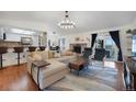Open-concept living room featuring a fireplace, modern furniture, and a smooth transition to the kitchen at 18714 E Utah Cir, Aurora, CO 80017