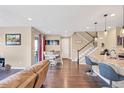 Open-concept living and dining area with hardwood floors and plenty of natural light at 7265 S Millbrook Ct, Aurora, CO 80016