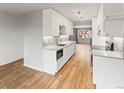 Well-lit kitchen with white cabinetry, stainless steel appliances, and a sleek design at 12893 W Alameda Dr, Lakewood, CO 80228