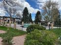 Community pool with mature trees and well-maintained landscaping at 12893 W Alameda Dr, Lakewood, CO 80228
