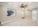 Bright living room with light wood floors, modern ceiling fan, and plenty of natural light at 1330 E 90Th Ave, Thornton, CO 80229