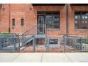 Charming brick building with a staircase leading to a front door and a small, gated courtyard at 2960 Inca St # 116, Denver, CO 80202