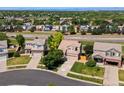 Aerial view of a suburban home with mature trees, well-manicured lawns, and a cul-de-sac at 18554 E Vassar Dr, Aurora, CO 80013