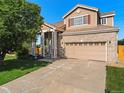 Charming two-story home featuring brick accents, red shutters, and a well-maintained lawn at 18554 E Vassar Dr, Aurora, CO 80013
